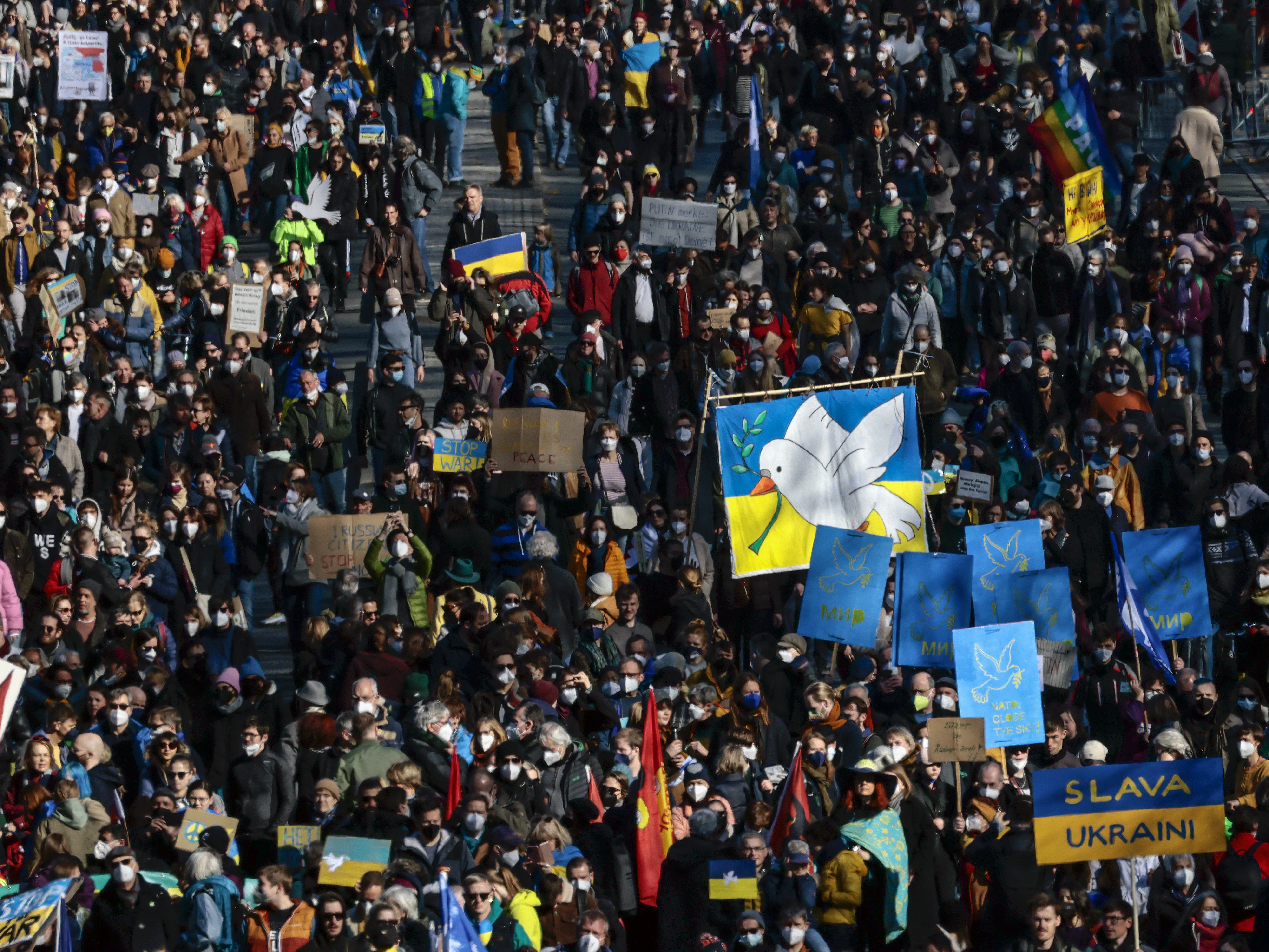 caption: People protesting Russia's invasion of Ukraine gather in Berlin on Sunday.