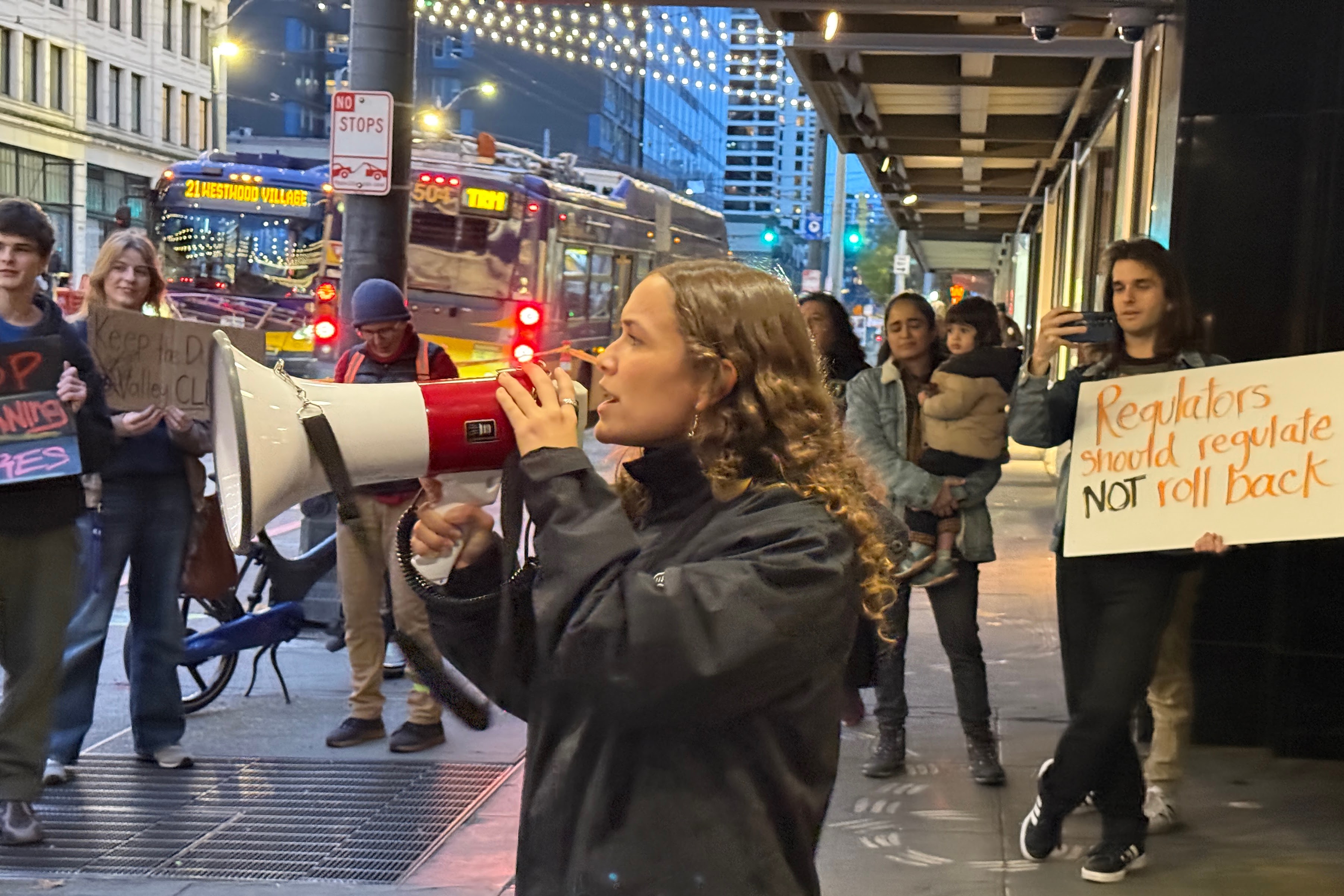 caption: Duwamish River Community Coalition activist Mia Ayala-Marshall speaks to a rally outside the offices of the Puget Sound Clean Air Agency in Seattle on Nov. 21, 2025.