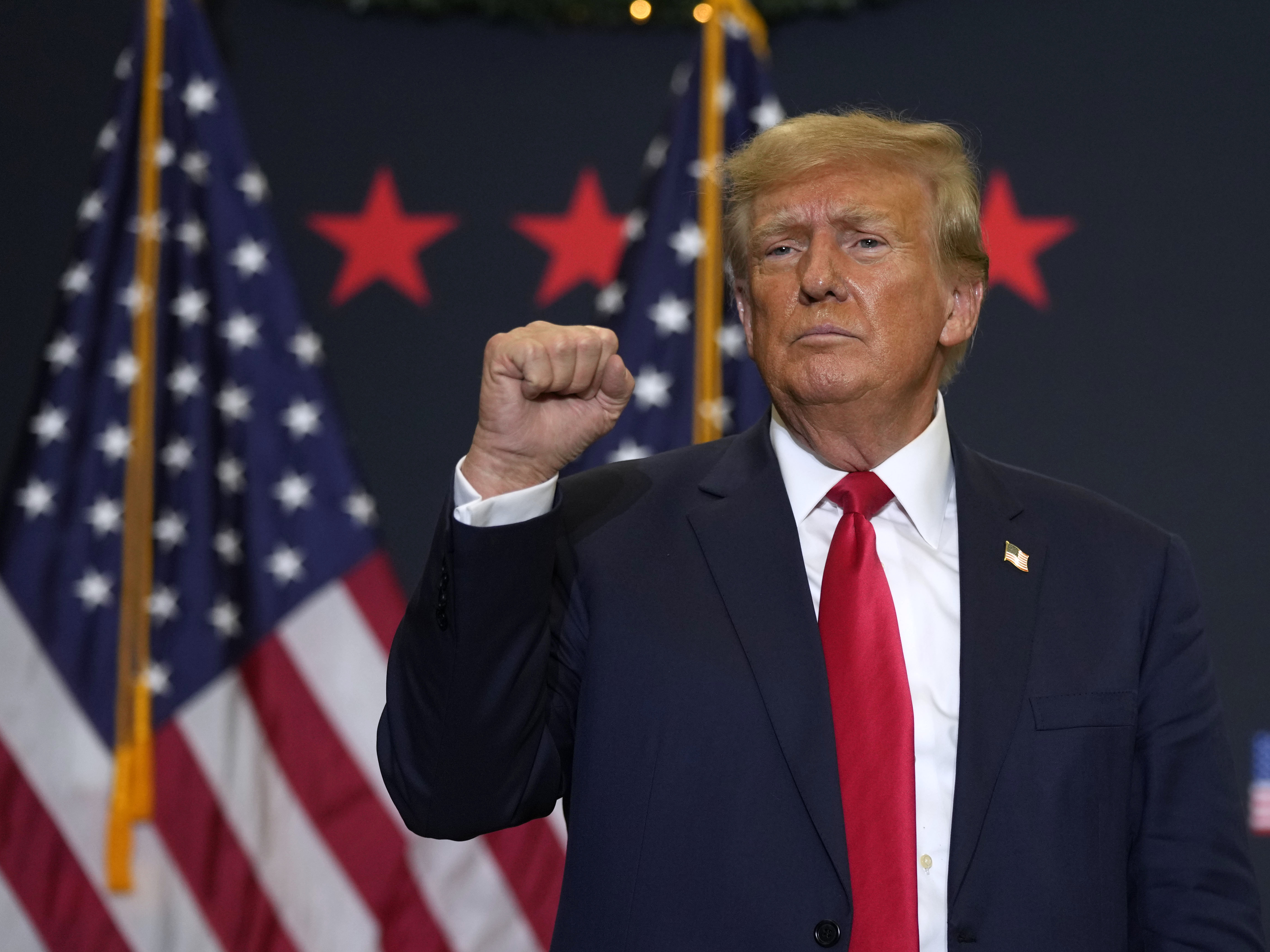 caption: Former President Donald Trump reacts to supporters during a commit to caucus rally, Tuesday, Dec. 19, 2023, in Waterloo, Iowa.