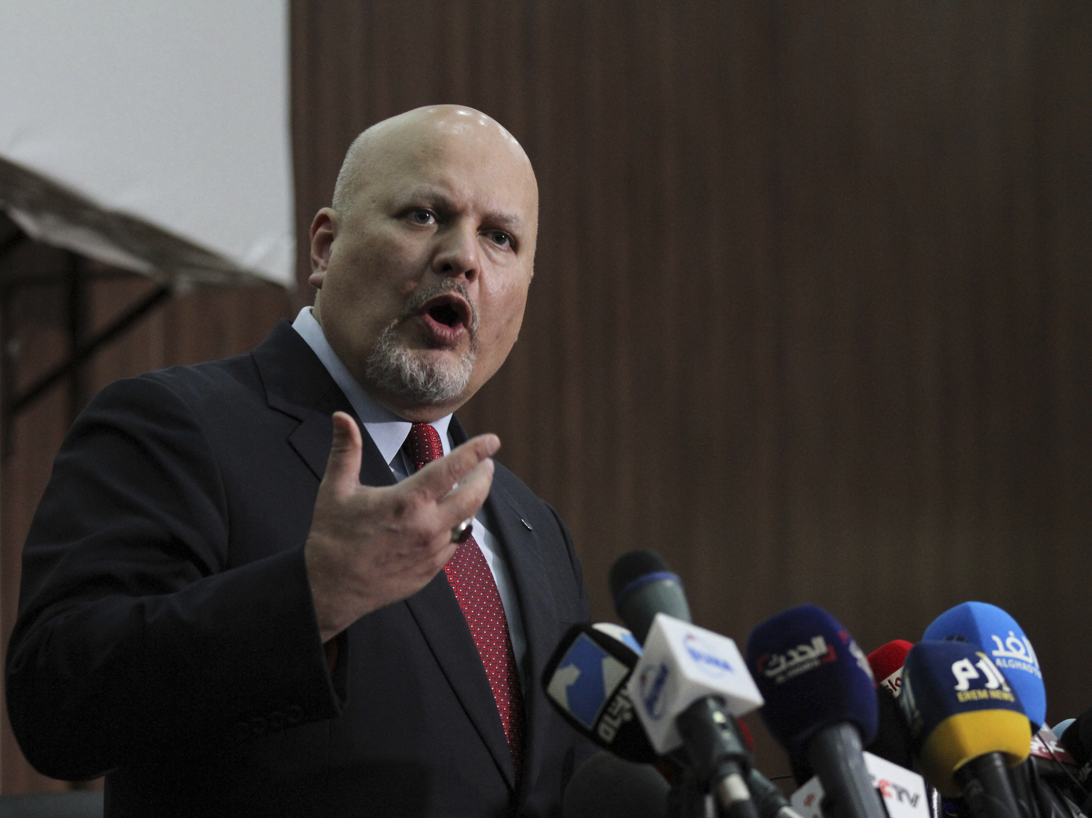 caption: Karim Ahmed Khan, International Criminal Court chief prosecutor, speaks during a news conference at the Ministry of Justice in the Khartoum, Sudan, last August. The International Criminal Court's prosecutor has put combatants and their commanders on notice that he is monitoring Russia's invasion of Ukraine and has jurisdiction to prosecute war crimes and crimes against humanity.