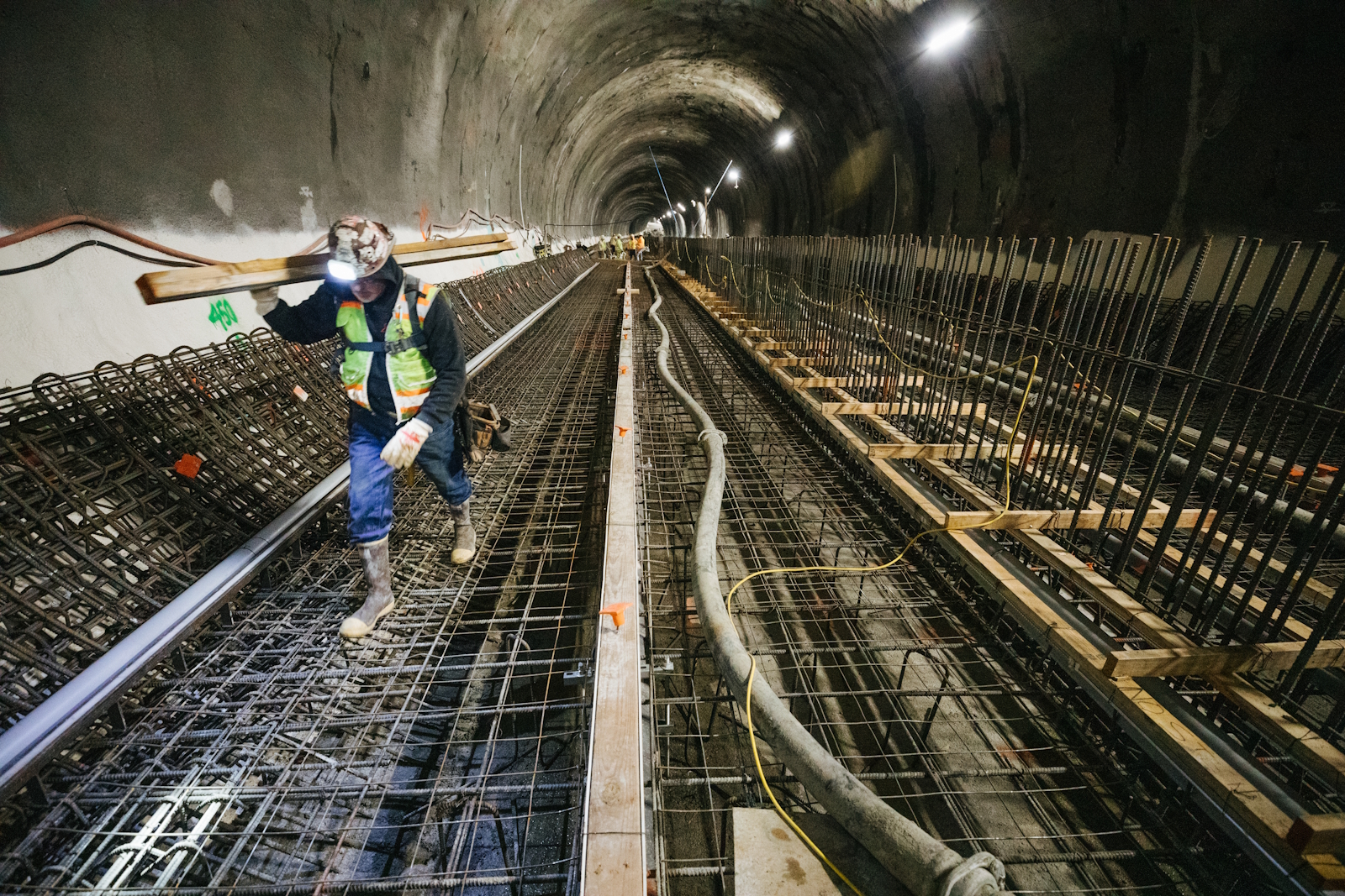 caption: This 2019 photo shows a construction worker in Sound Transit's tunnel beneath downtown Bellevue, which has since been completed and is home to the 2-line today.