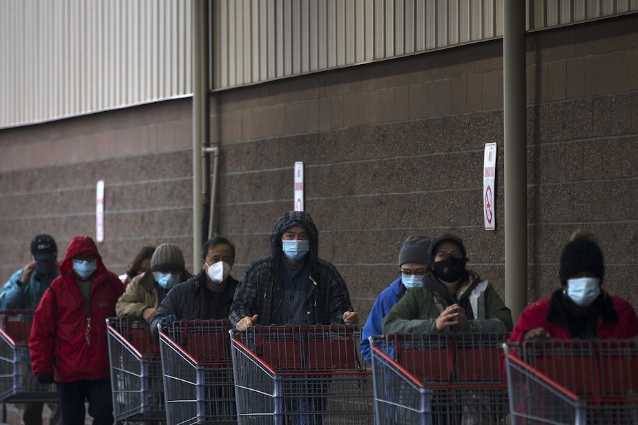 caption: A line forms outside of Costco on Monday, November 16, 2020, on 4th Avenue South in Seattle. New statewide restrictions were announced by Gov. Jay Inslee on Sunday to curb the rapid spread of Covid-19. 