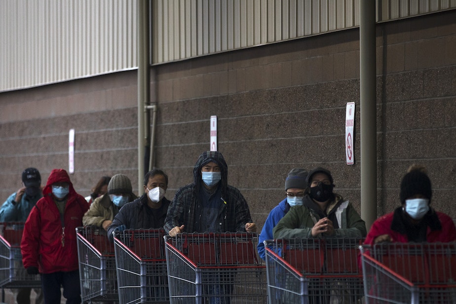 caption: A line forms outside of Costco on Monday, November 16, 2020, on 4th Avenue South in Seattle. New statewide restrictions were announced by Gov. Jay Inslee on Sunday to curb the rapid spread of Covid-19.