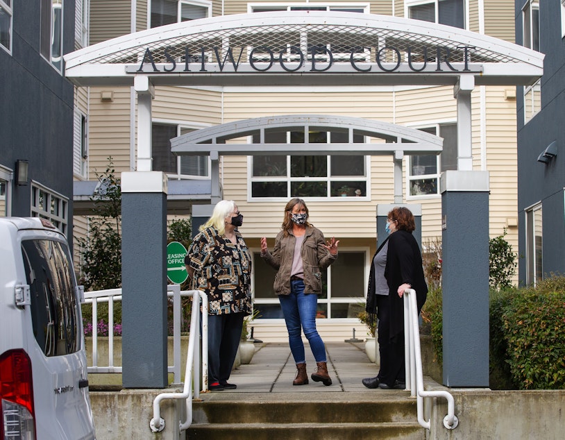 caption: Kim Loveall Price, center, director of a nonprofit that operates Ashwood Court, a low-income housing complex in Bellevue, Wash., talks with residents Susanne Sherman, right, and Joyce Hansbearry. 