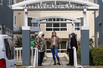 caption: Kim Loveall Price, center, director of a nonprofit that operates Ashwood Court, a low-income housing complex in Bellevue, Wash., talks with residents Susanne Sherman, right, and Joyce Hansbearry. 