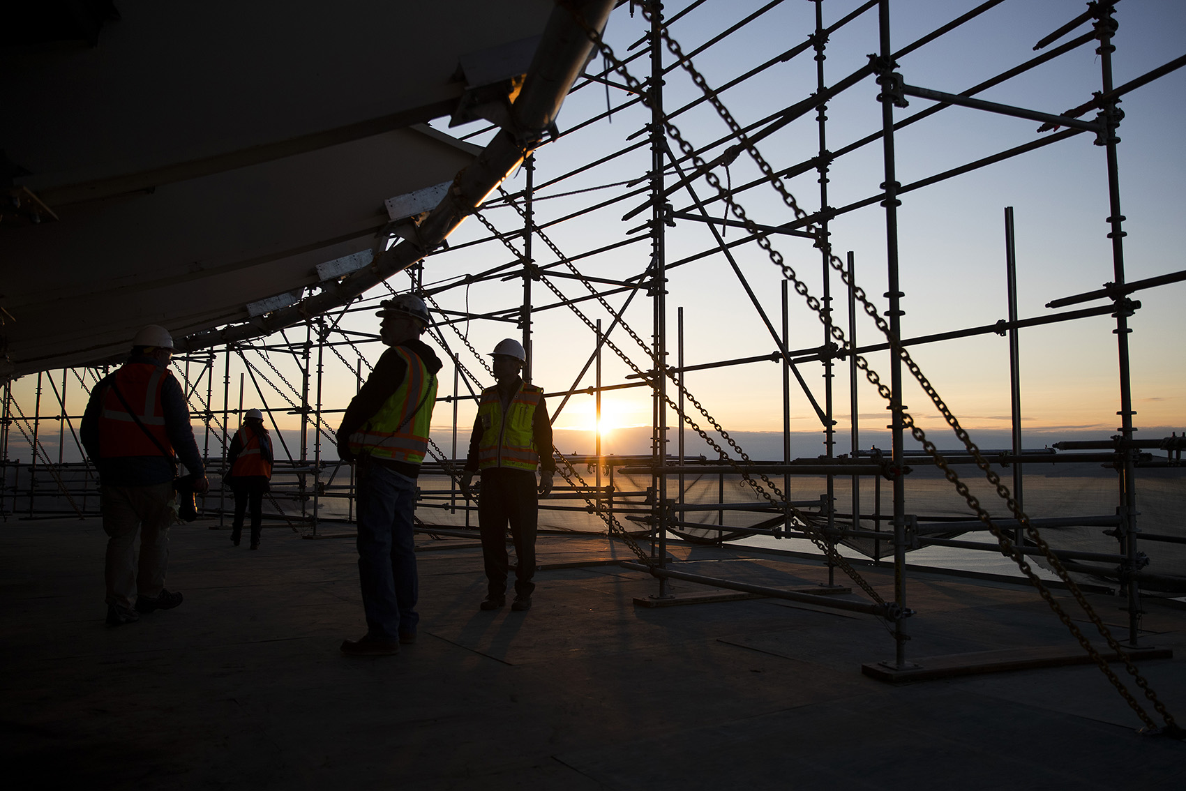 caption: The sunset is shown from a suspended scaffolding below the new rotating restaurant in the Space Needle on Monday, November 6, 2017, in Seattle. Tap or click on the first image to see more.