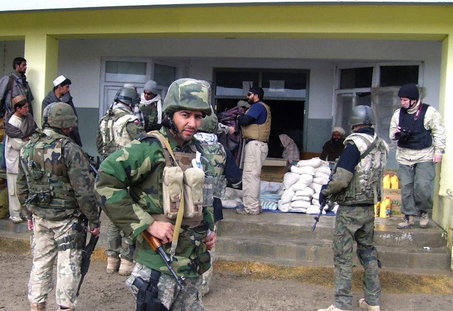 caption: Janis Shinwari wearing his body armor in Afghanistan in 2008. He worked with U.S. troops in some of the most dangerous parts of the country, and the Taliban put him on a 'kill list.'