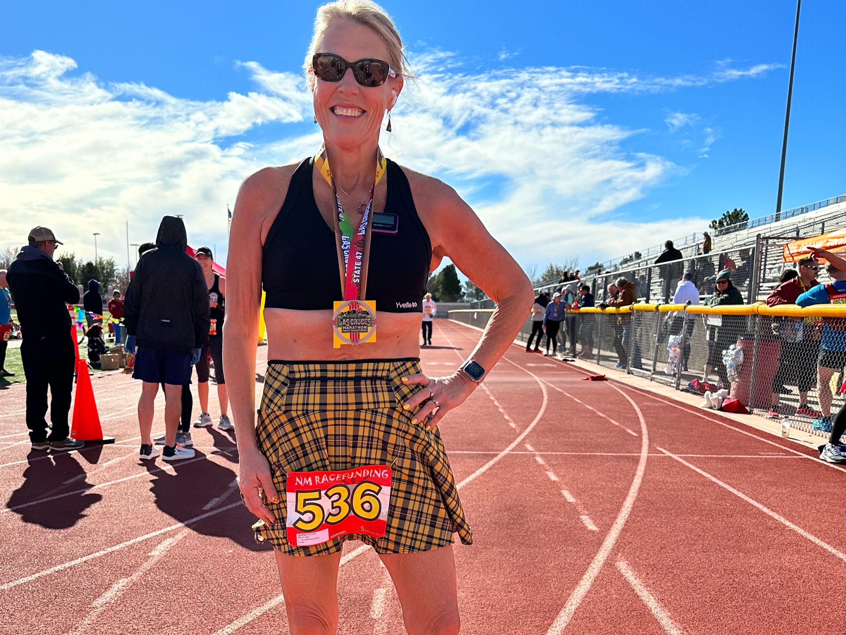 caption: After deciding to try to run a half-marathon in all 50 states, Christie Woodard completed one in Las Cruces, N.M., in 2023. She's working to stay fit and strong since getting bariatric surgery for obesity and going on GLP-1 drugs to maintain a healthy weight.