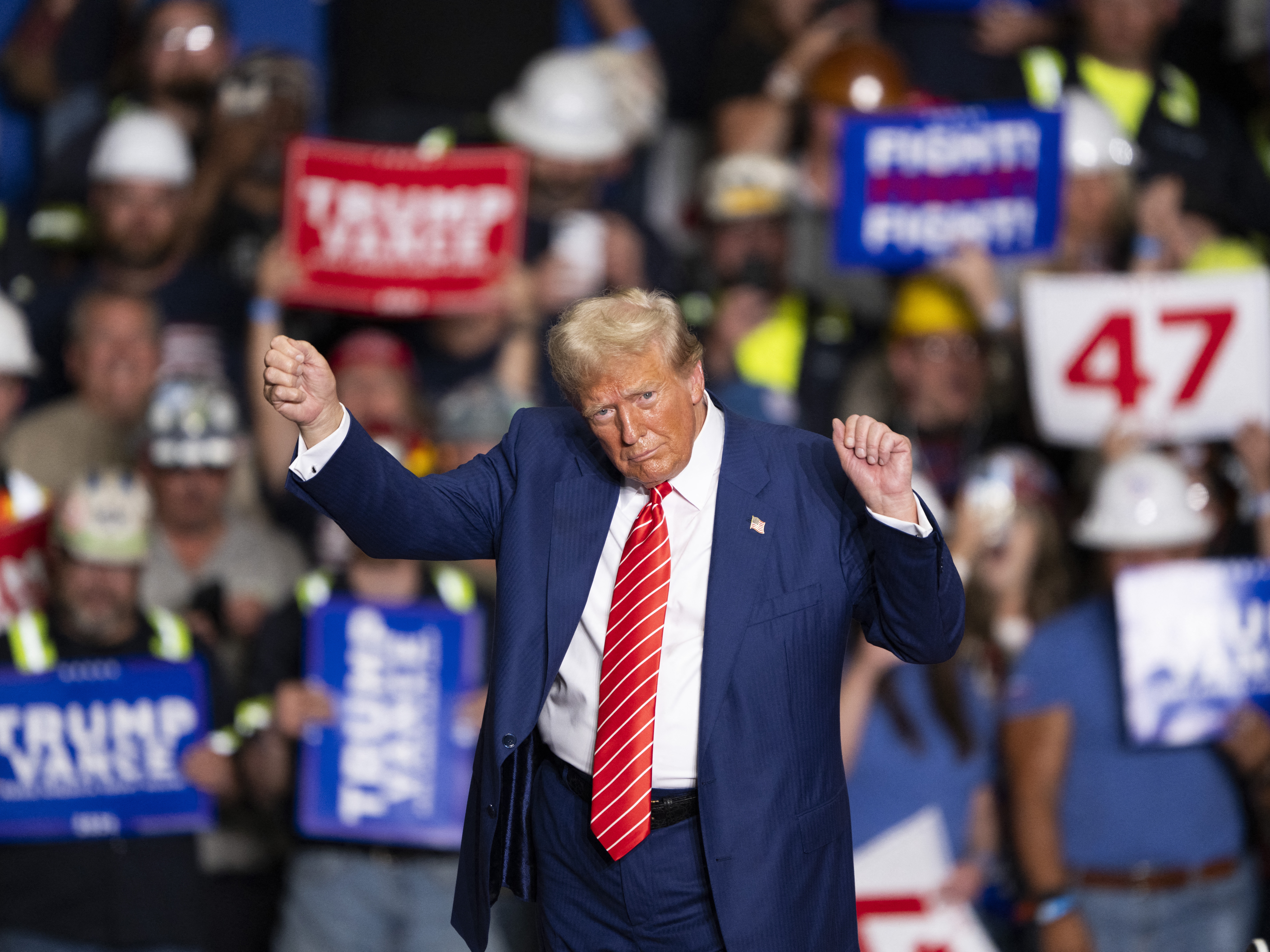 caption: Former President Donald Trump dances to a song as he leaves a rally in Johnstown, Pa., on Aug. 30.