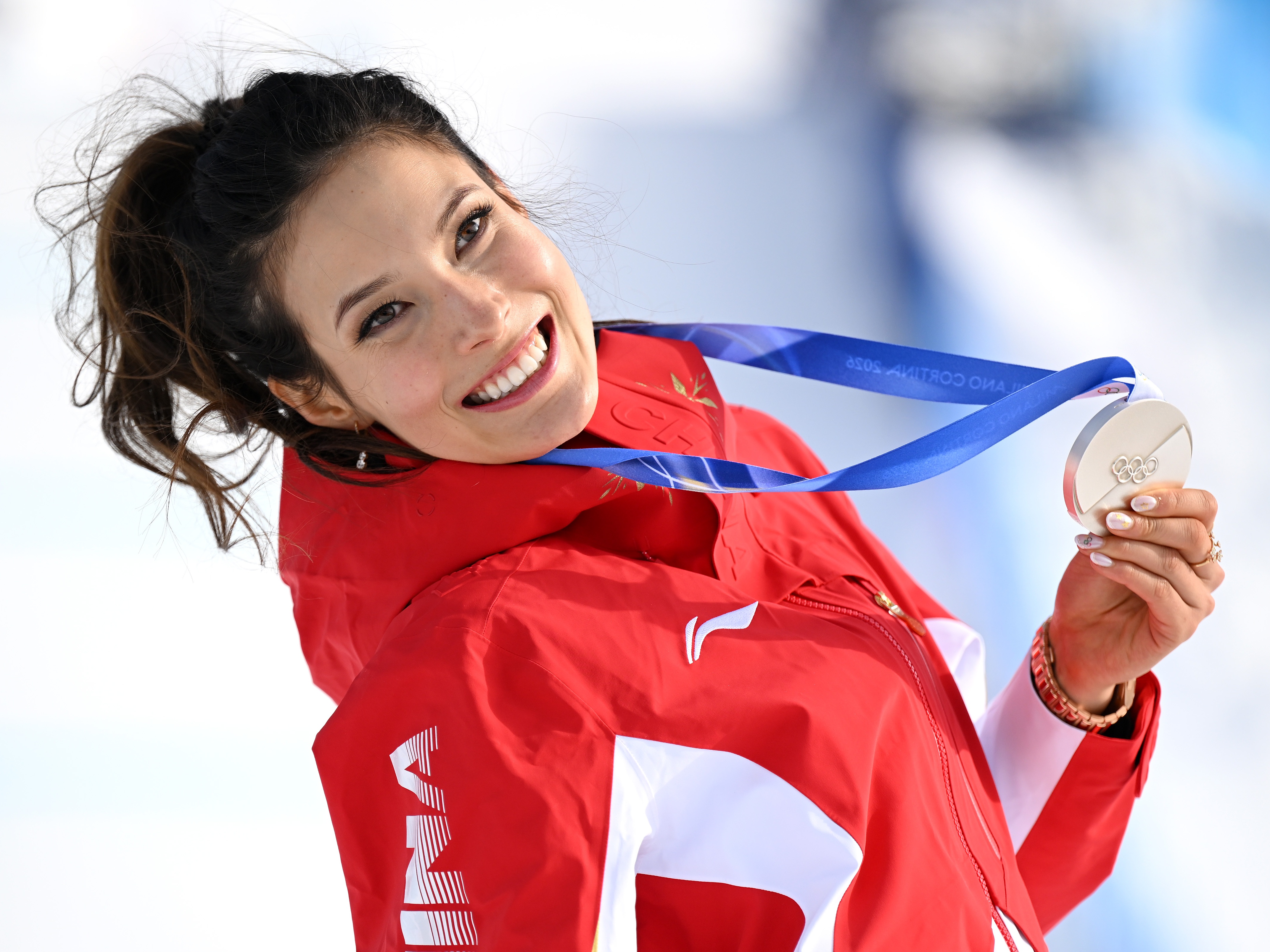 caption: Eileen Gu celebrates her silver medal for China at the Women's Slopestyle Final during the Milan Cortina 2026 Winter Olympic Games in Livigno, Italy.