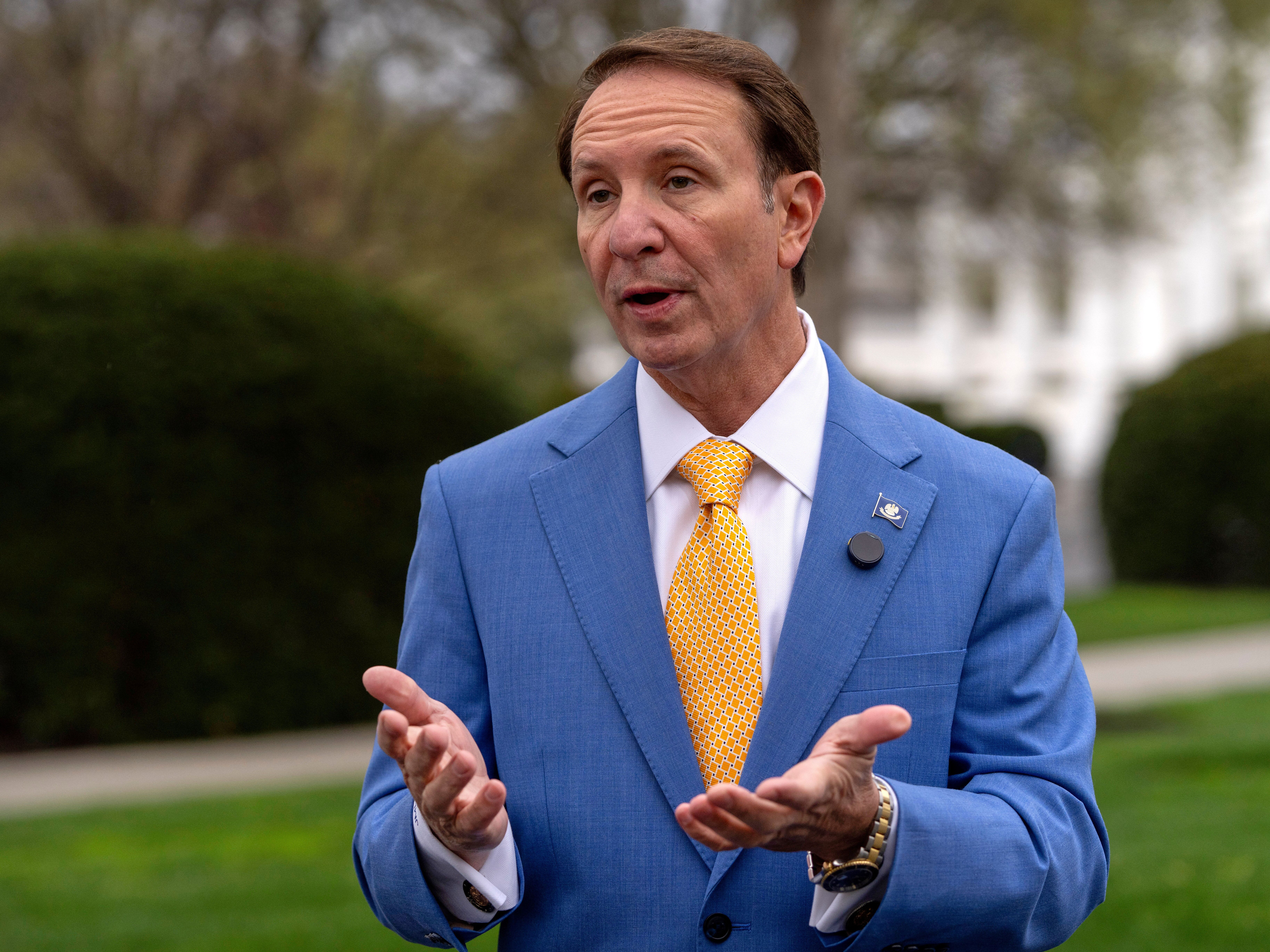 caption: Louisiana Gov. Jeff Landry records a social media video outside the White House on March 24, 2025.