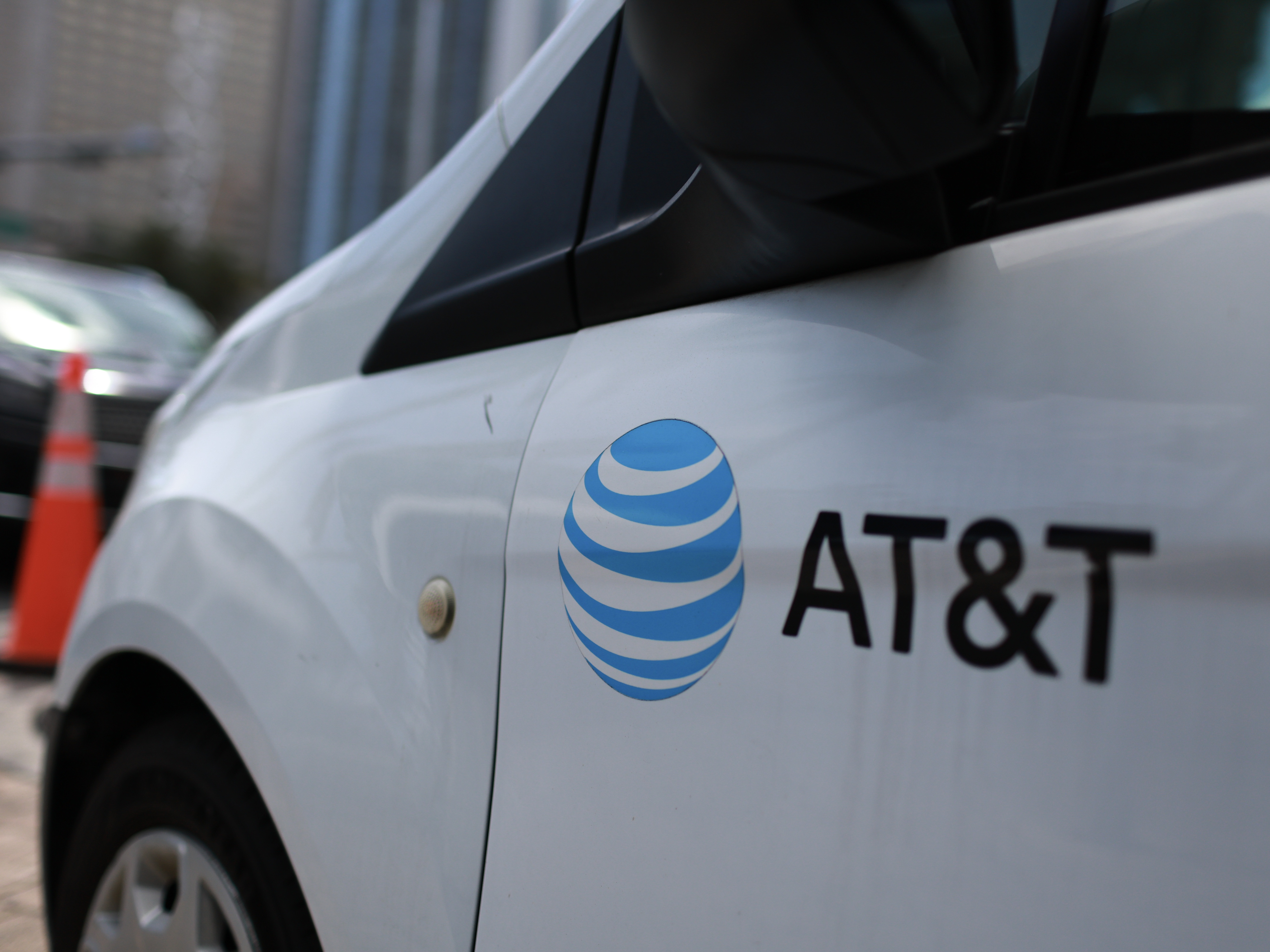 caption: An AT&amp;T logo adorns a worker's van on April 1 in Miami, Fla.