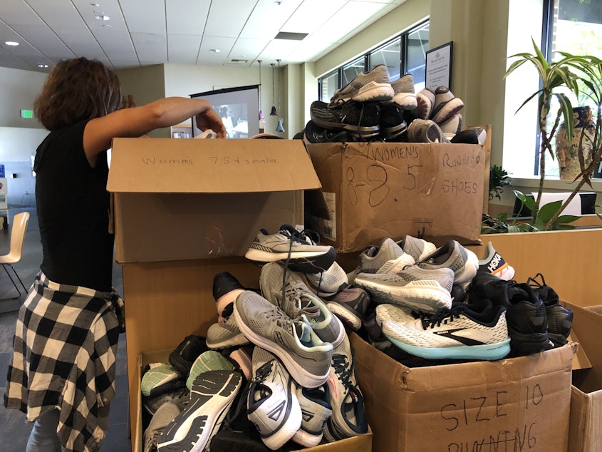 caption: At its monthly resource fair, Recovery Café provides shoes to members who need them. 