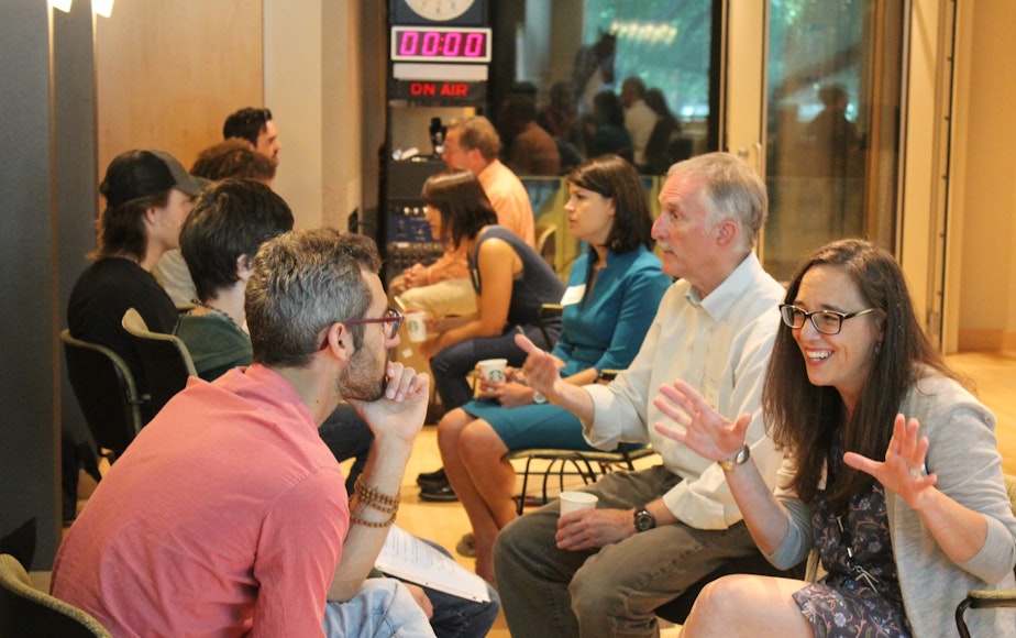 caption: Participants (left) ask journalists (right) their questions about the current state of media. Front to back is KUOW reporter Patricia Murphy, George Erb and Natalie Brand.