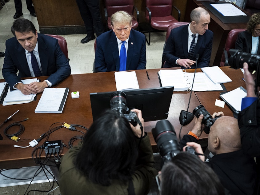 caption: Former U.S. President Donald Trump (C), flanked by attorneys Todd Blanche (L) and Emil Bove (R), arrives for his criminal trial as jury selection continues at Manhattan Criminal Court on April 18, 2024 in New York City.