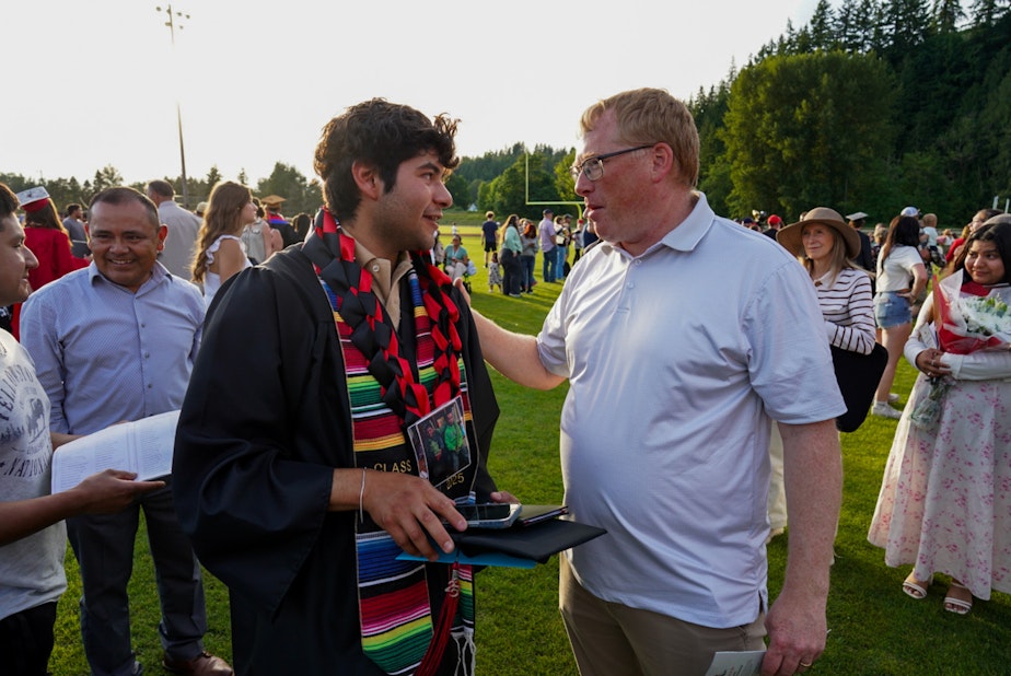 caption: Alex Guerrero Villatoro and his former soccer coach, Mike Barksdale, chat briefly at his graduation Thursday, June 5.