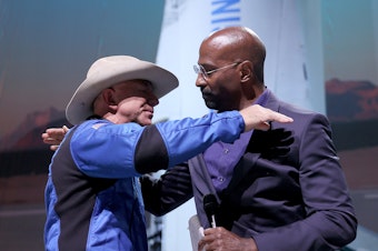 caption: Jeff Bezos hugs Van Jones, founder of Dream Corps, on Tuesday after announcing a $200 million award to him and chef José Andrés for charities of their choice.