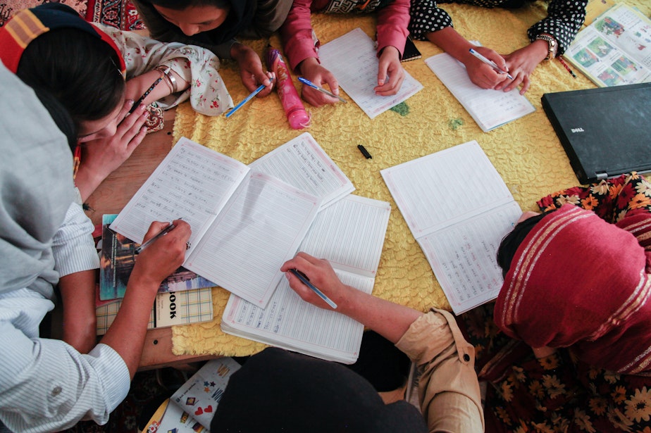 caption: Girls study at a secret school on the outskirts of Kabul in July of 2022.