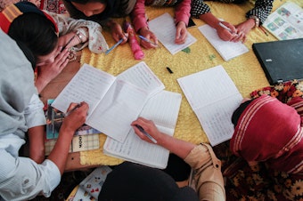 caption: Girls study at a secret school on the outskirts of Kabul in July of 2022.