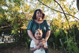 caption: Meralyn Kirkland with her granddaughter, Kaia Rolle.