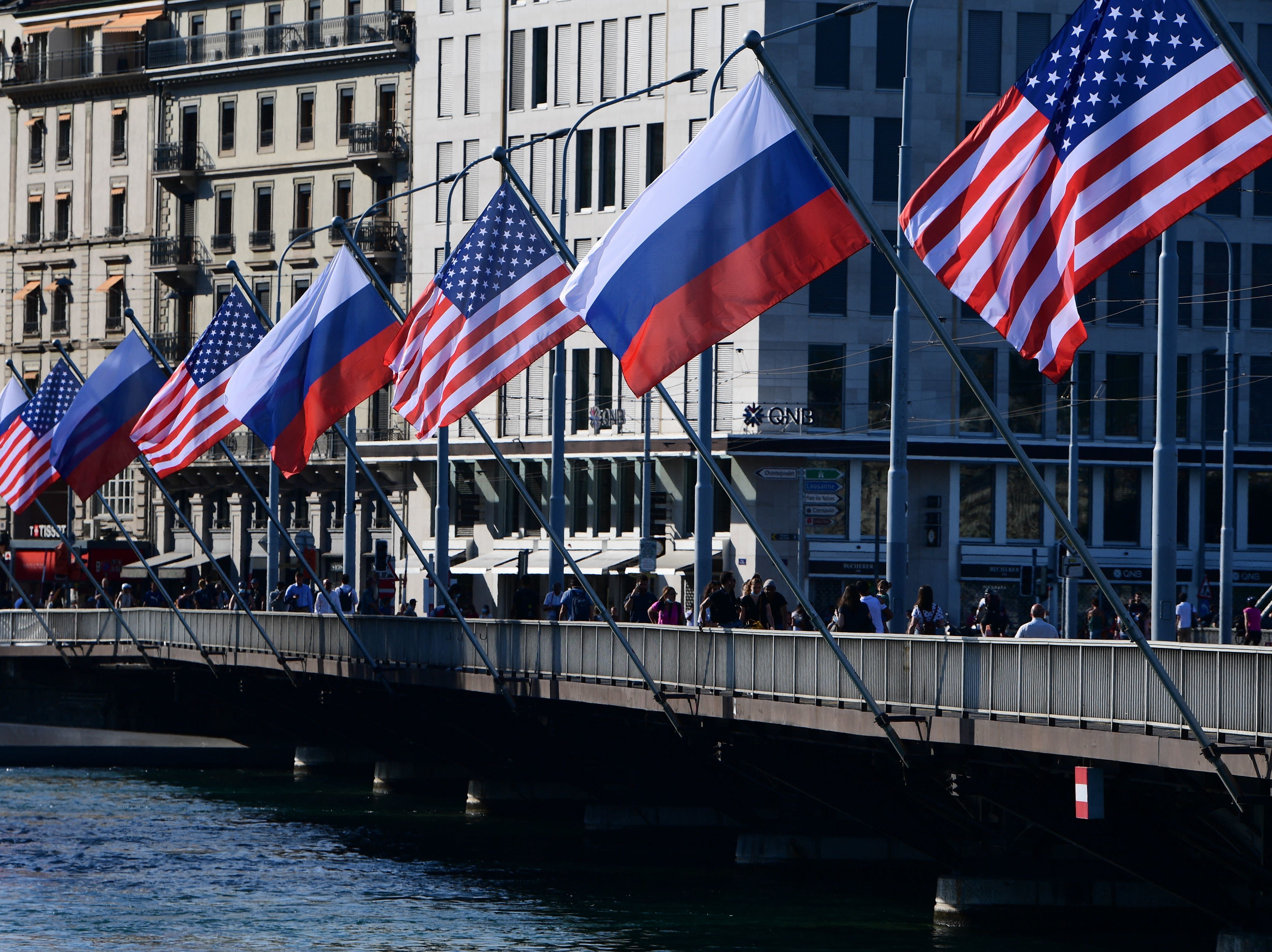 caption: U.S. and Russian flags fly on the Mont-Blanc bridge on the eve of a US-Russia summit on Tuesday in Geneva. A former intelligence operative says agencies are in high gear.