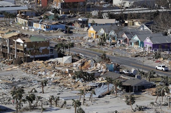 caption: The devastation from Hurricane Michael over Mexico Beach, Fla. A massive federal report released in November warns that climate change is fueling extreme weather disasters like hurricanes and wildfires.