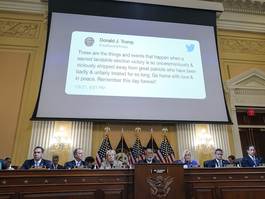 caption: A tweet by former President Donald Trump is displayed on a screen during a hearing held by the House Jan. 6 committee on June 9.