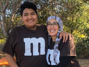 caption: Feda Almaliti with her son, 15-year-old Muhammed, who has severe autism. "Muhammed is an energetic, loving boy who doesn't understand what's going on right now," she says.