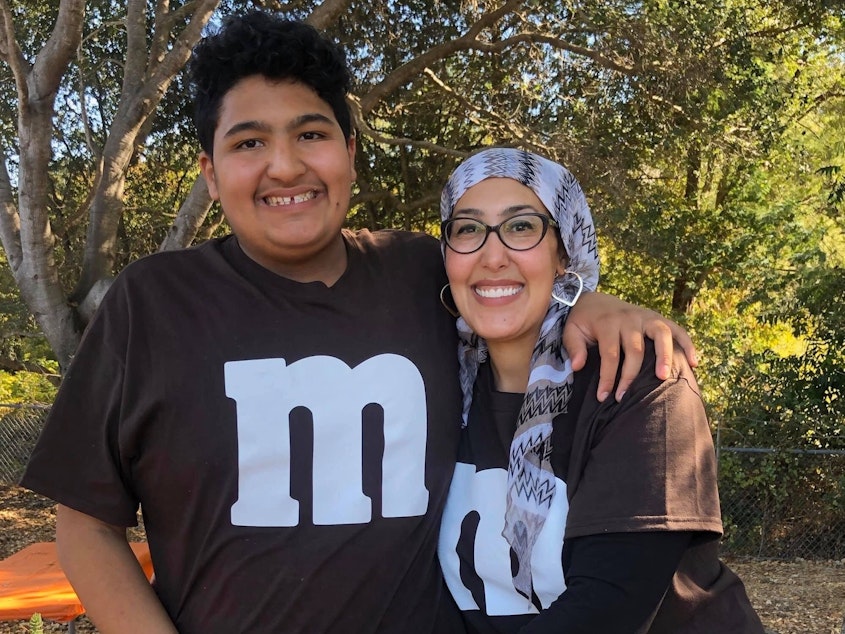 caption: Feda Almaliti with her son, 15-year-old Muhammed, who has severe autism. "Muhammed is an energetic, loving boy who doesn't understand what's going on right now," she says.