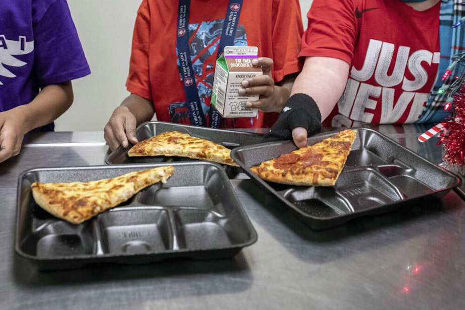caption: Second-grade students select their meals during lunch break in the cafeteria. (Alberto Mariani/AP)