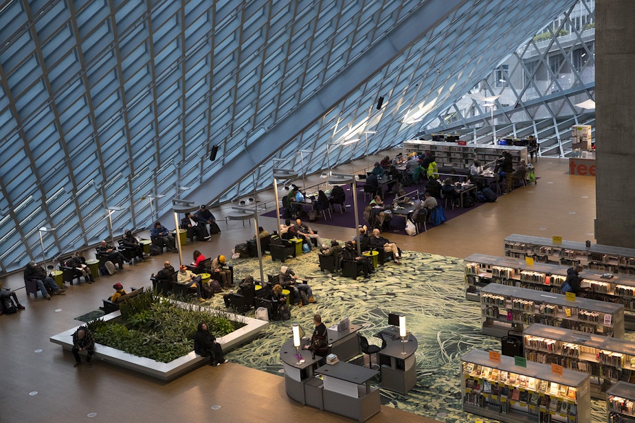 caption: Patrons are shown inside the Seattle Public Library Central branch on Thursday, January 2, 2020, on 4th Avenue in Seattle. As of January 2, late fees for overdue books have ended.