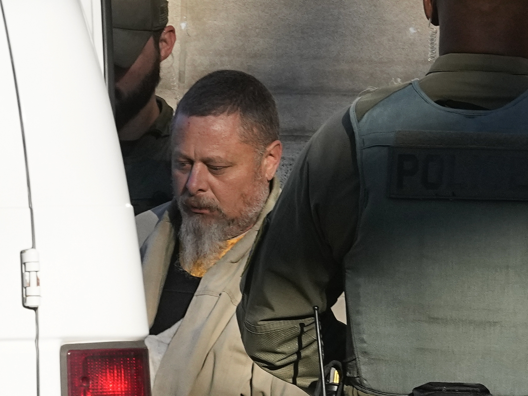 caption: Officers escort Richard Allen out of the Carroll County courthouse following a hearing, Nov. 22, 2022, in Delphi, Ind.