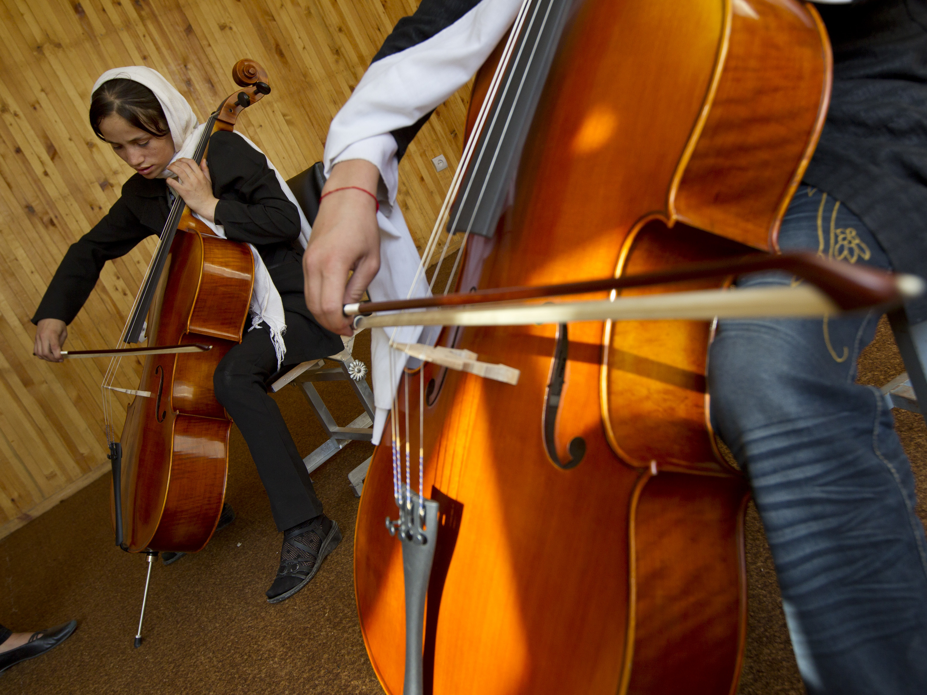 caption: Students practice the cello during class at the Afghanistan National Institute of Music on Sept. 26, 2010 in Kabul.