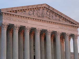 caption: The setting sun illuminates the Supreme Court building on Capitol Hill in Washington on Jan. 10, 2023.