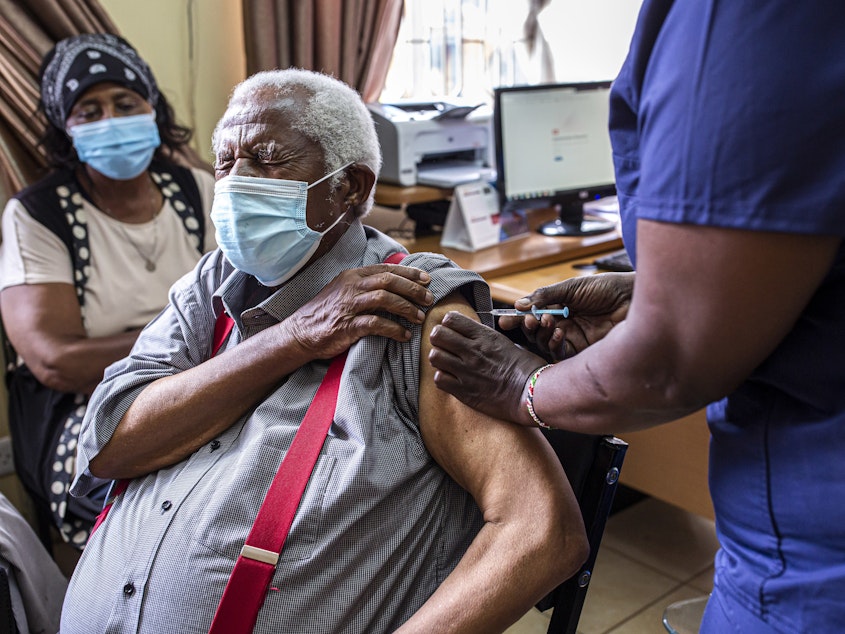 caption: An older person receives their first dose of the AstraZeneca vaccine in Thika, Kenya. The vaccine's manufacturer, Serum Institute of India, announced this week that it will freeze all exports of the vaccine through the end of this year — leaving 20 million people in Africa without a source for their second dose.