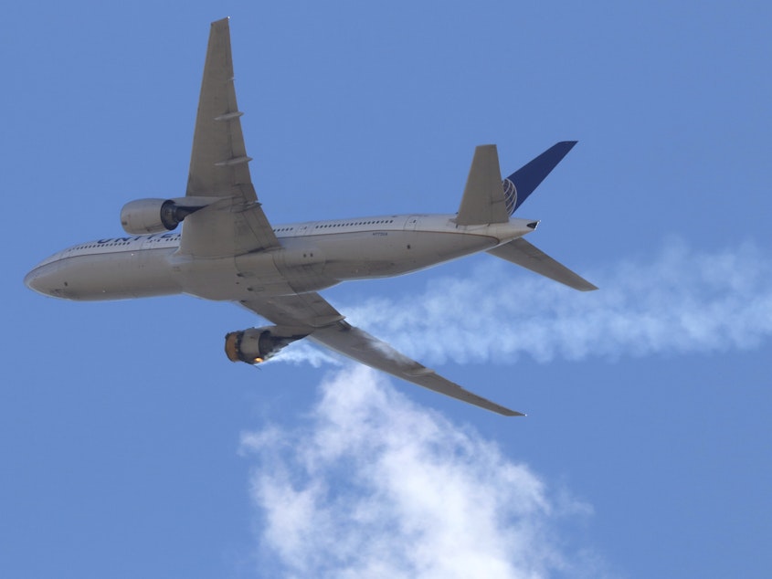caption: United Airlines Flight 328 approaching Denver International Airport, after experiencing "a right-engine failure" shortly after takeoff from Denver. The FAA issued an order on Tuesday grounding all aircraft powered by the same Pratt & Whitney 4000-112 engine until they've been inspected.