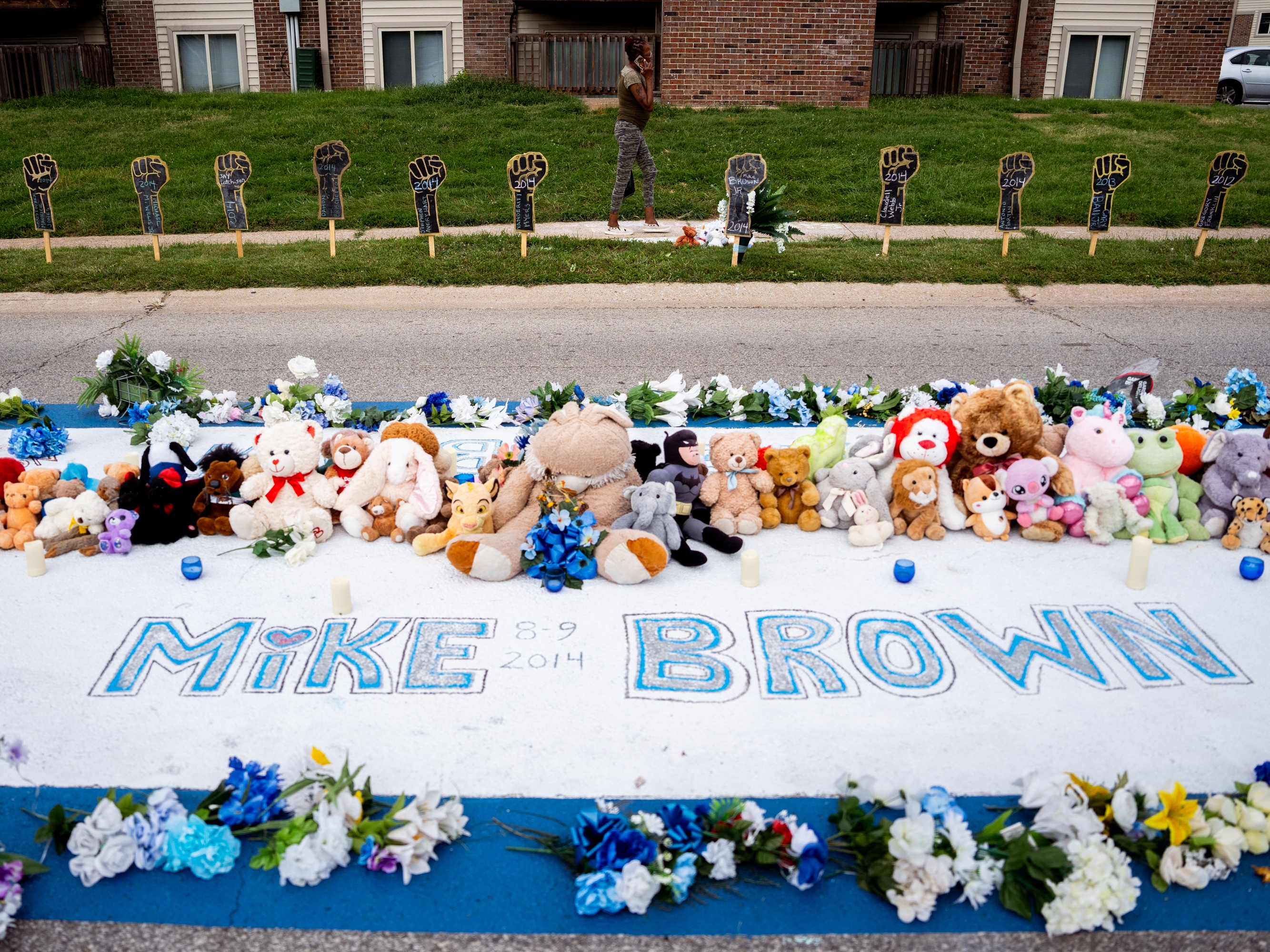 caption: A memorial for Michael Brown Jr. stands on the site he was killed in 2014 by a white Ferguson police officer on Tuesday, Aug. 6, 2024, along Canfield Drive in Ferguson.