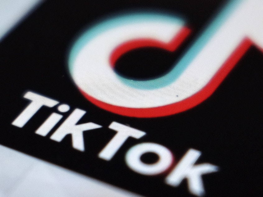caption: TikTok says it is banning all accounts that share content related to the QAnon conspiracy theory, hardening its previous policy on the far-right movement.