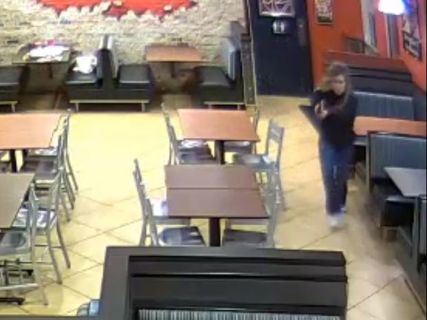 caption: Detective Chase McKeown and Officer Nicole McKeown drew their guns and closed in on a robbery suspect in a fried chicken restaurant in Louisville, Ky., Saturday night.