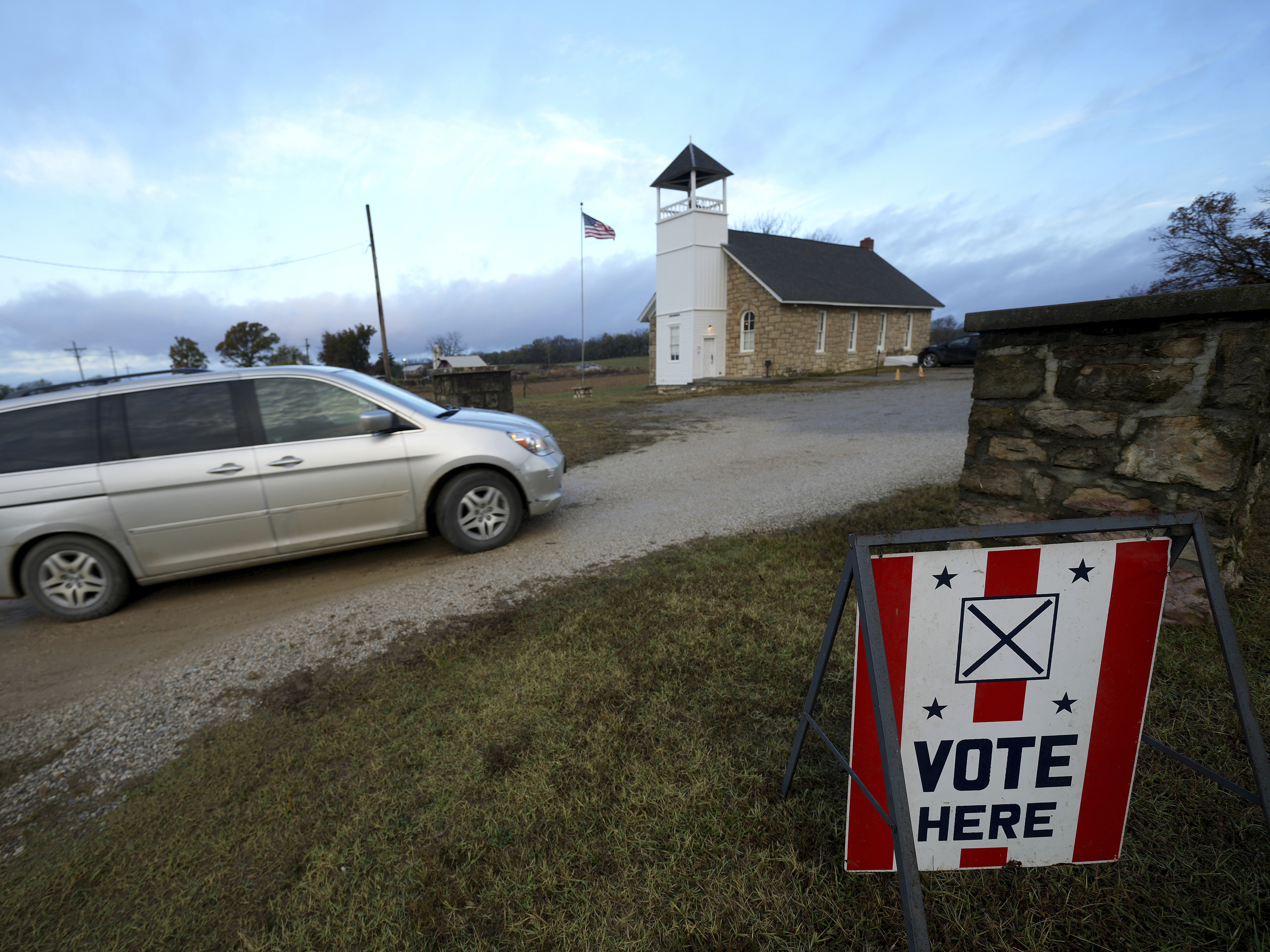 caption: Voters arrive at the Buck Creek School to vote on Election Day, Nov. 5, 2024, in rural Perry, Kan.