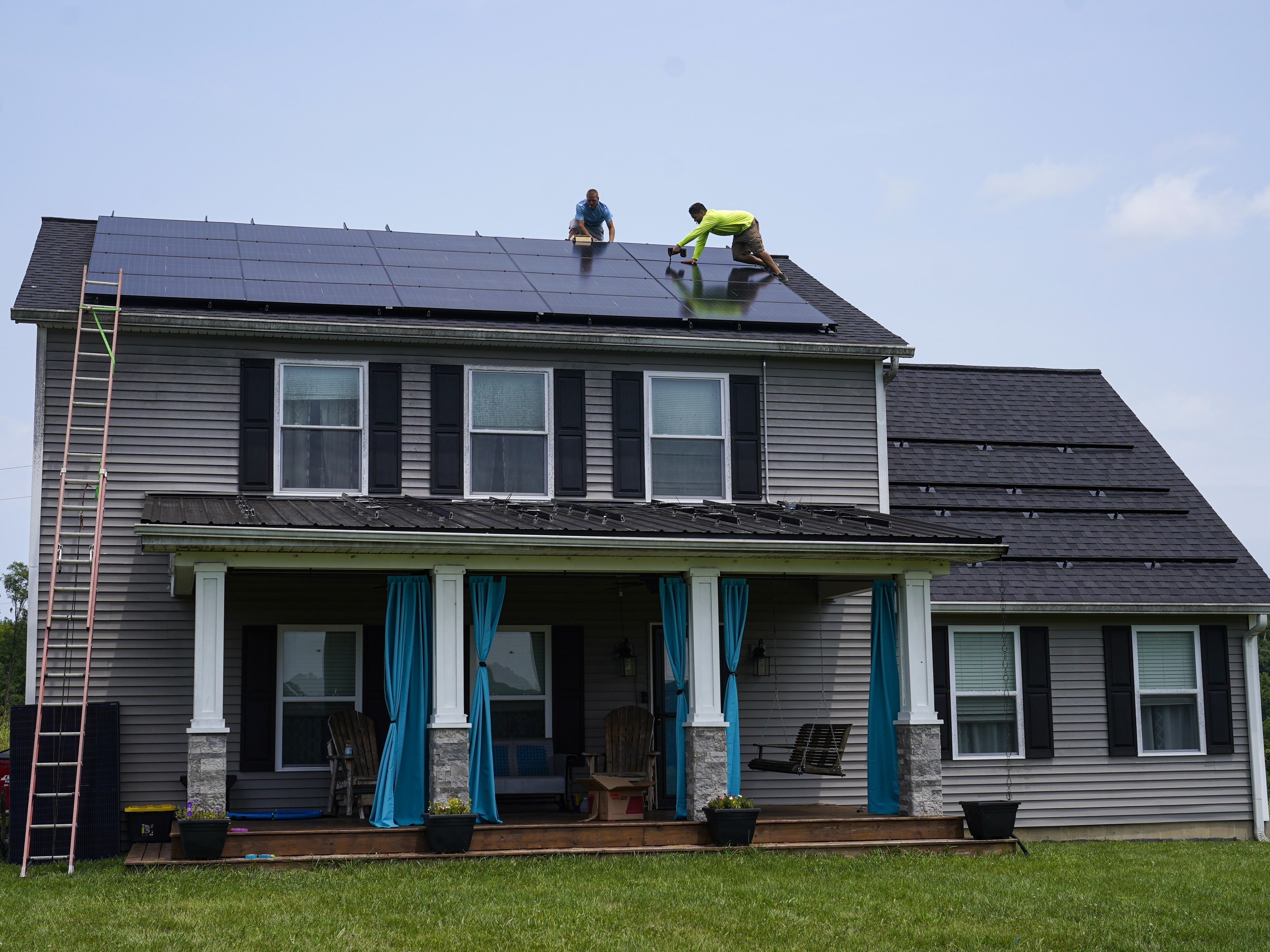 caption: Solar panels are installed on the roof of a home in Frankfort, Ky., in 2023. Residential solar is booming in the U.S., but customer complaints have increased even more. 