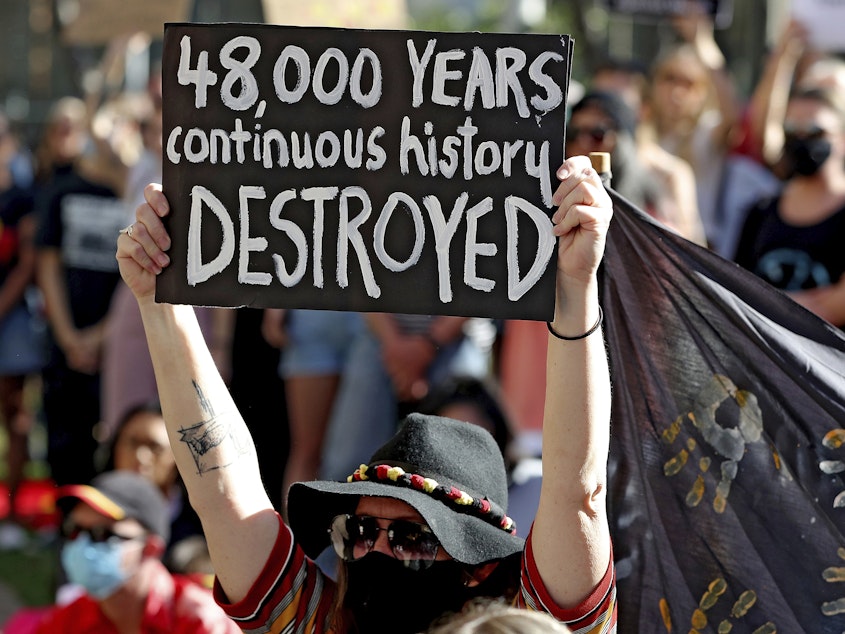 caption: Protesters rallied outside the Rio Tinto office in June in Perth, Australia, after the destruction of Indigenous heritage sites the month before.
