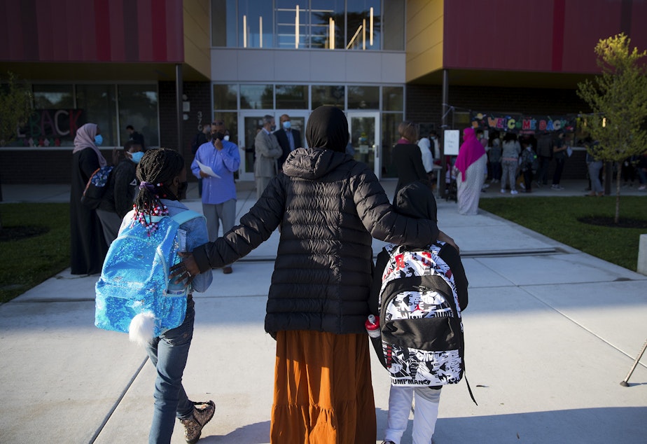 caption: Students arrive for the first day of school at Wing Luke Elementary School on Wednesday, September 1, 2021, along Kenyon Street in Seattle.