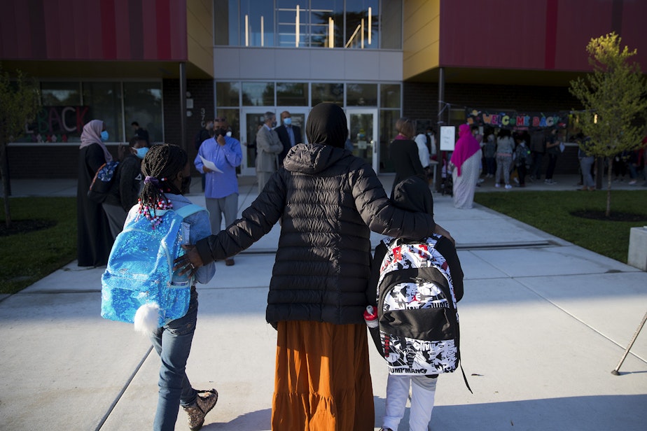 caption: Students arrive for the first day of school at Wing Luke Elementary School on Wednesday, September 1, 2021, along Kenyon Street in Seattle.