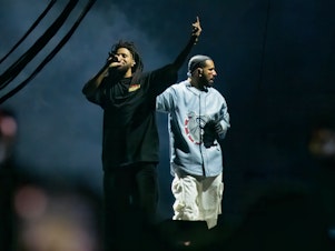 caption: J. Cole and Drake perform during the 2023 edition of Cole's Dreamville festival in Raleigh, N.C., last April. Their collaborative track "First Person Shooter" recently touched off a war of words with fellow MC Kendrick Lamar.