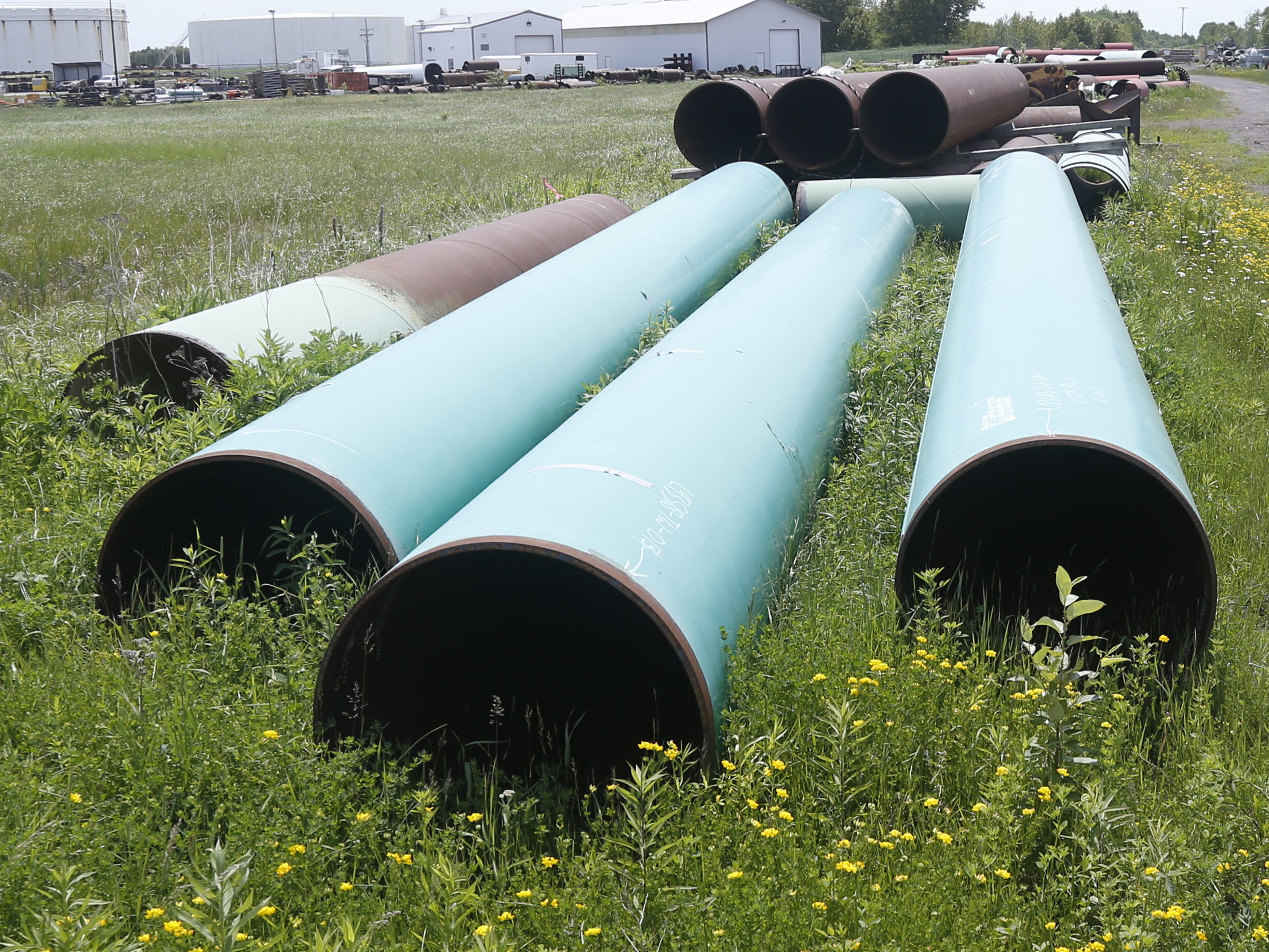 caption: Pipeline used to carry crude oil is shown at the Superior, Wis., terminal of Enbridge Energy, on June 29, 2018. The Biden administration is restoring federal regulations guiding environmental reviews of major infrastructure projects.