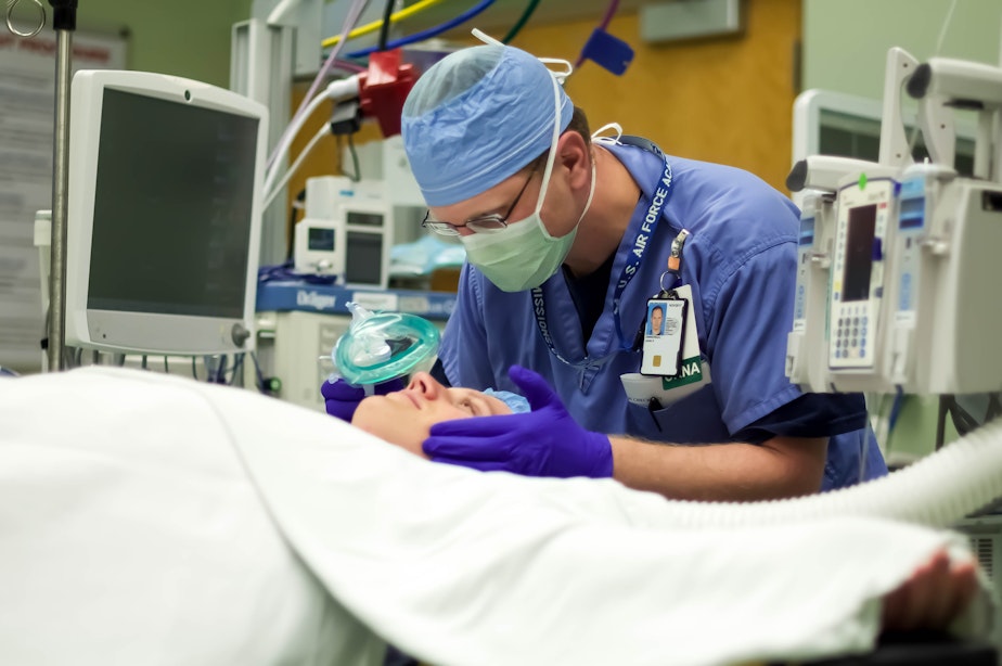 caption: John Zimmerman, a nurse anesthetist for the Veterans Administration in Minneapolis, leans over a patient. Under a proposed rule, nurse anesthetists would be allowed to work independently rather than under a physician's close supervision.