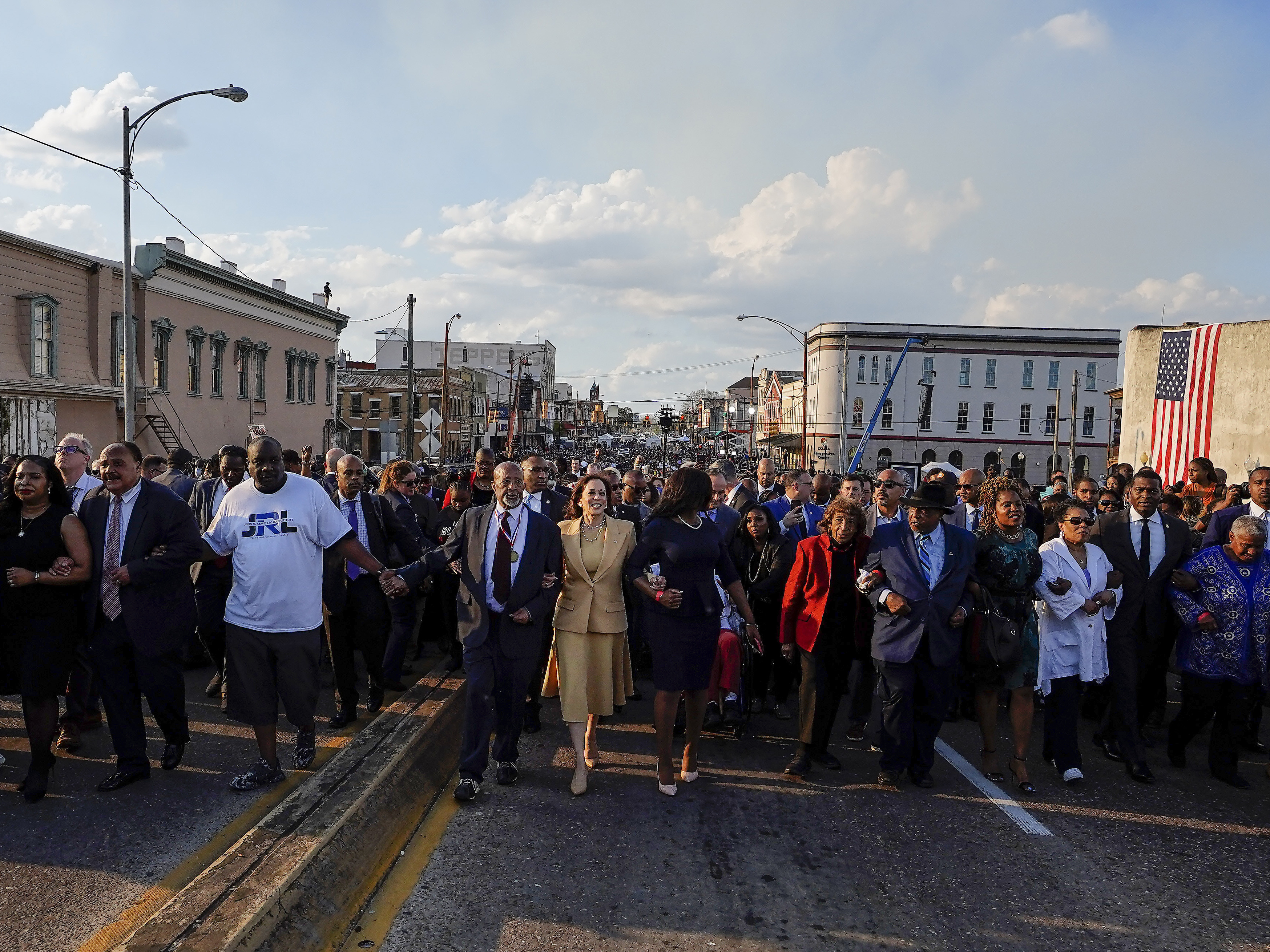 caption: Vice President Kamala Harris marches on the Edmund Pettus Bridge after speaking in Selma, Ala., on Sunday.