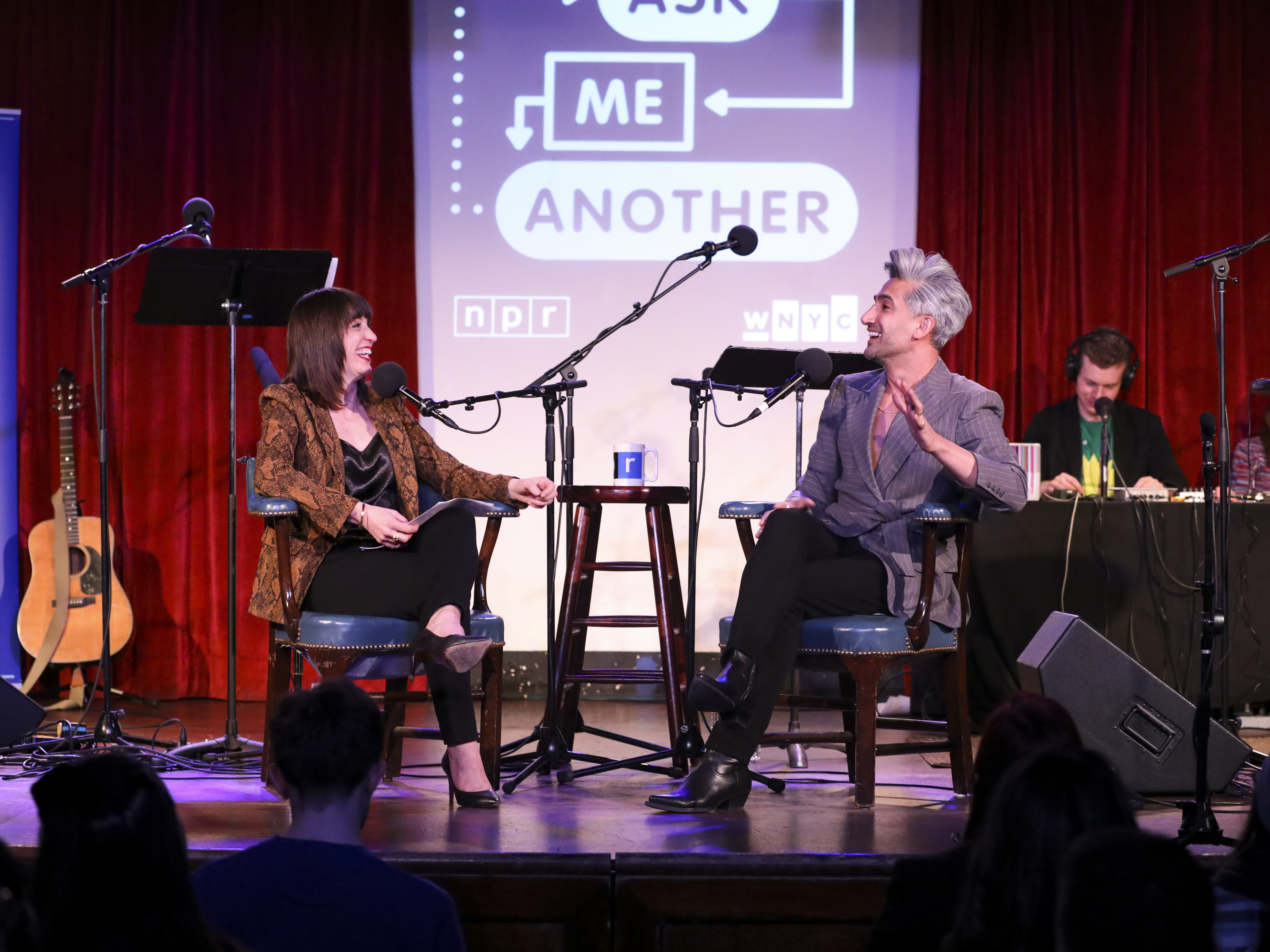 caption: Tan France plays a game with Ophira Eisenberg on <em>Ask Me Another</em> at the Bell House in Brooklyn, New York.