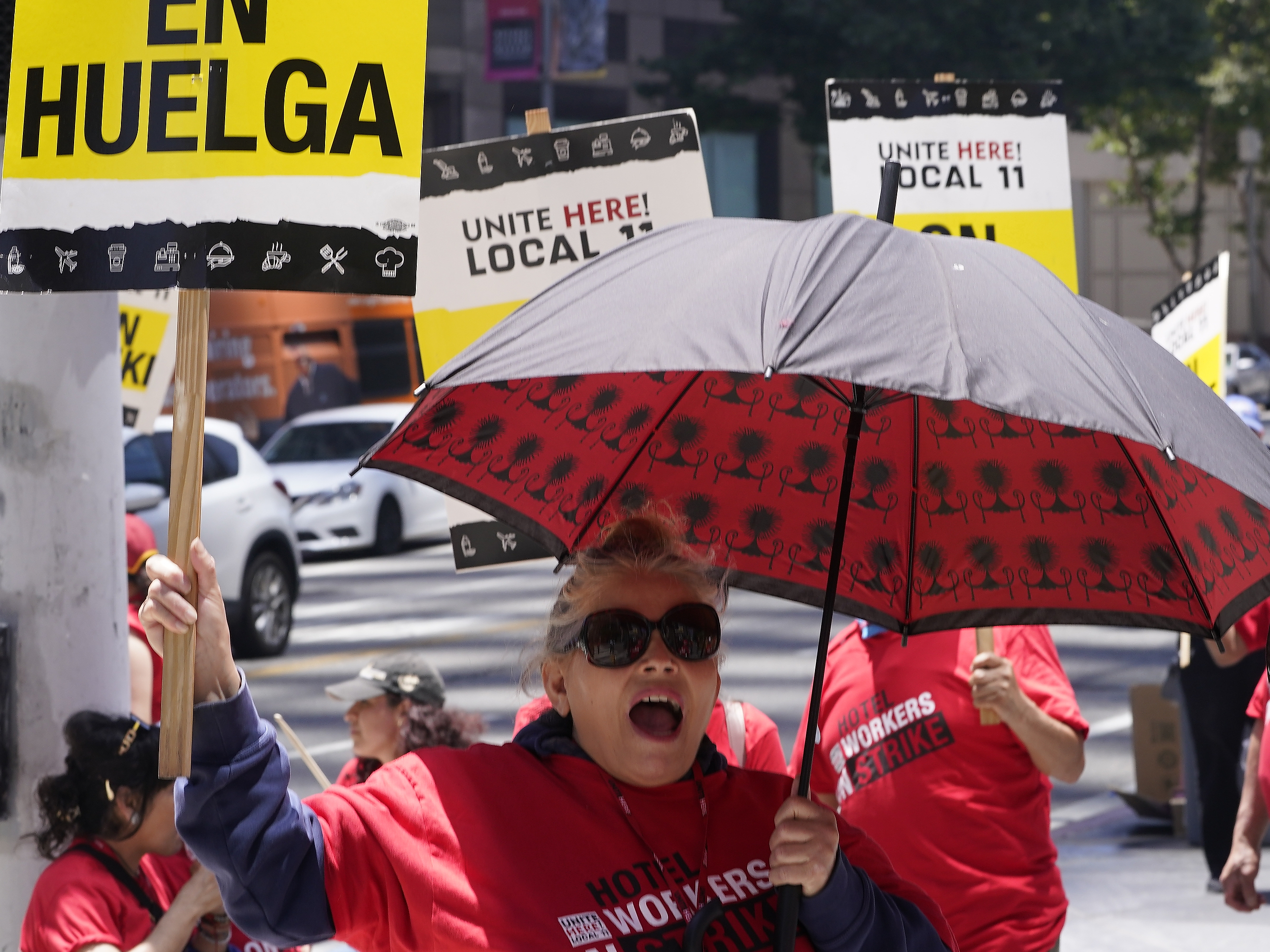 caption: Striking hotel workers rally outside the InterContinental Los Angeles Downtown Hotel on Tuesday, July 4, 2023. (AP Photo/Damian Dovarganes)